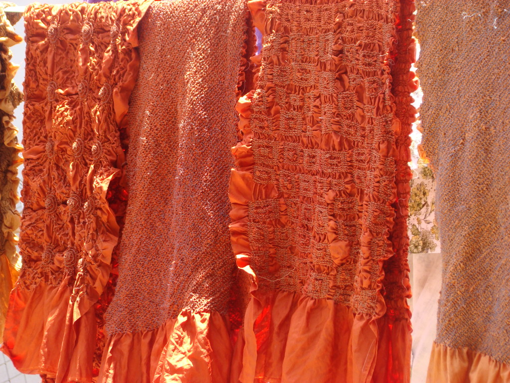 Some of Kamaldeep's vibrant orange bandhani scarves
