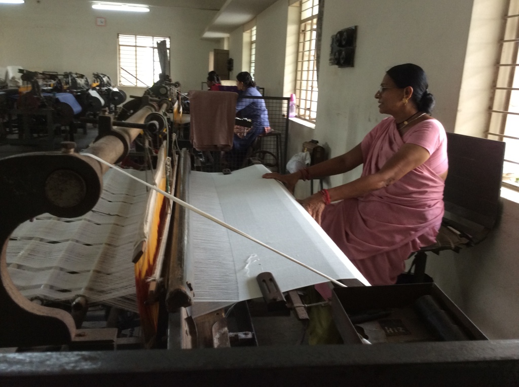 One of the ladies working at the loom