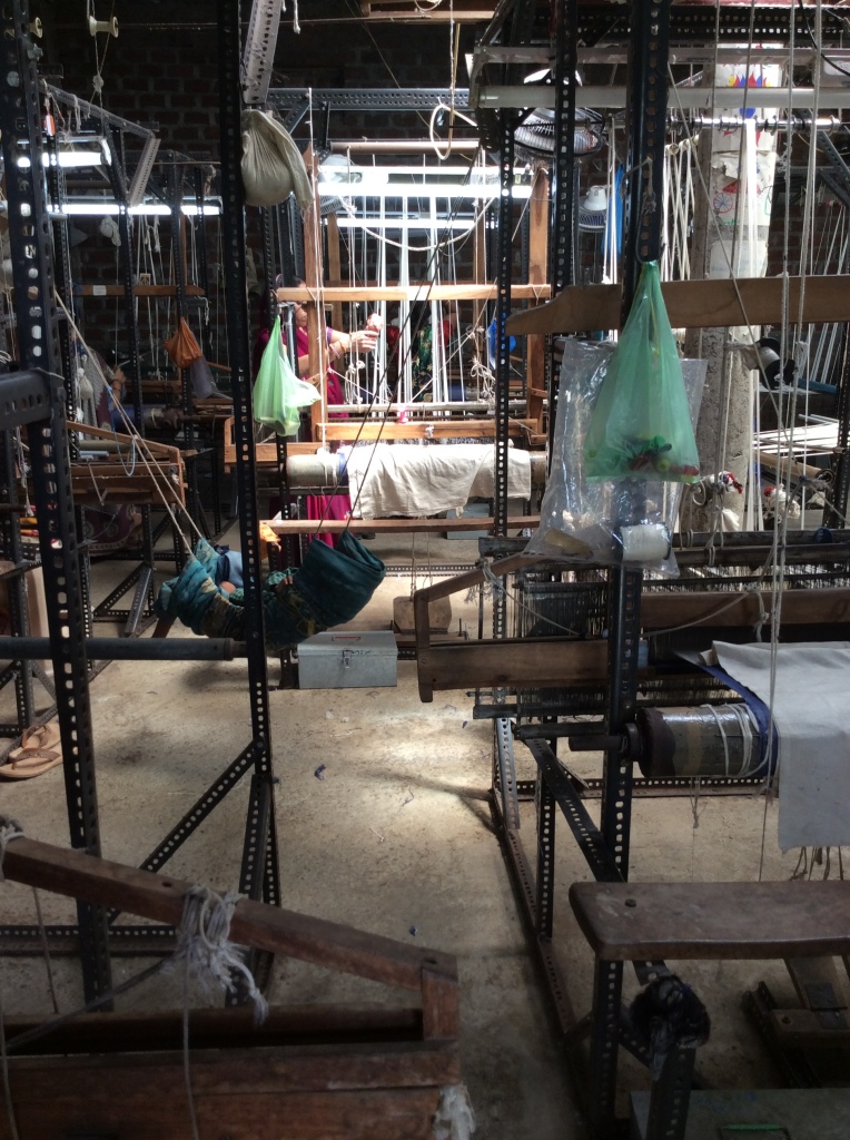 The workshop at Itwadi. A weaver's baby is sleeping in a hammock, rocked by the sound of the looms