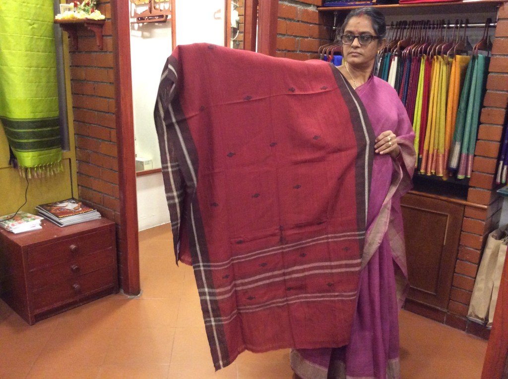 A shop assistant in Shilpi showing me a dupatta woven by a tribal community in Madhya Pradesh and dyed in natural dyes