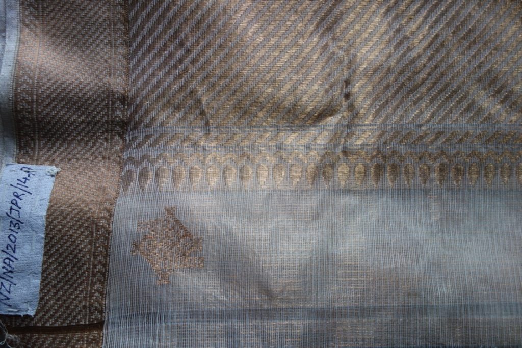 The kota doria GI mark woven into the border of a sari